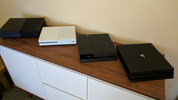 The Pro (right) is bulkier than the original PS4 and the new Xbox One S, although it's still not as big or heavy as the launch Xbox One (left).