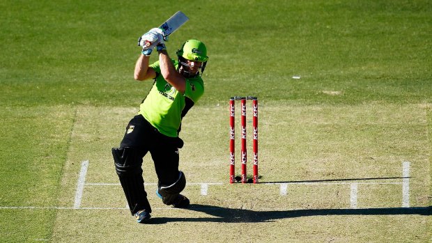 Storm warning: Aiden Blizzard smashes a ball down the ground for the Sydney Thunder.