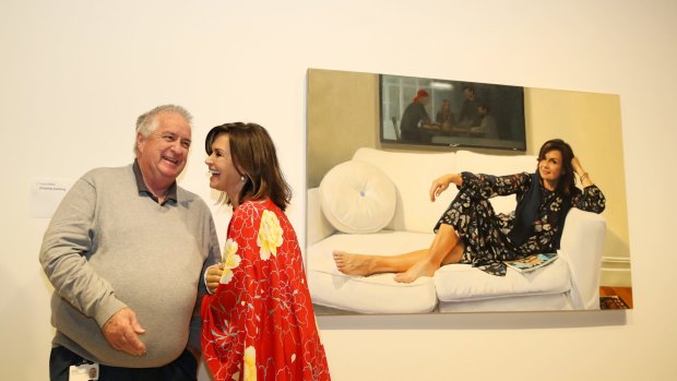 Lisa Wilkinson with Art Gallery of NSW head packer Steve Peters in front of Peter Smeeth's portrait of her.  