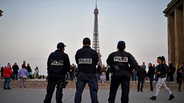 Police secure the centre of Paris the day after a gunman opened fire on officers.