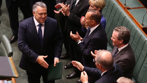 Happier times: Mr Hockey is congratulated by colleagues after his second budget in May this year.