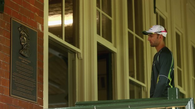 Pausing to reflect: Nathan Lyon walks past the commemorative plaque erected in a tribute to the late Phillip Hughes at Sydney Cricket Ground.