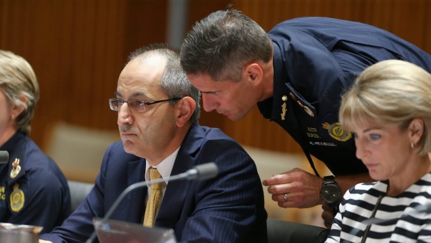 Border Force commissioner Roman Quaedvlieg (note the smart uniform) whispers sweet briefings into Immigration Department secretary Mike Pezzullo's ear.