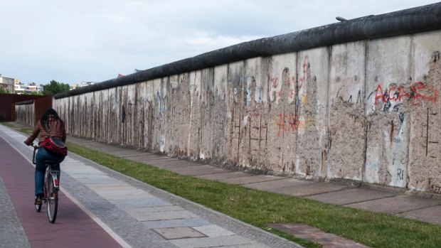 A cyclist passes the Berlin Wall memorial at Bernauer Strasse. 
