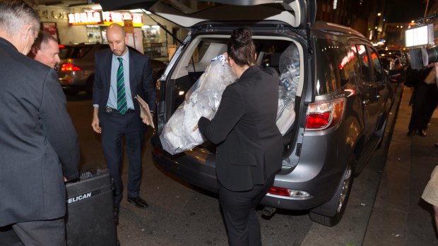 Australian Federal Police remove shredded documents and other evidence during a raid the NSW AWU offices.