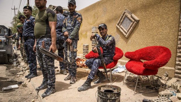 Iraqi federal police just behind the front lines in the al-Risala district of Fallujah.