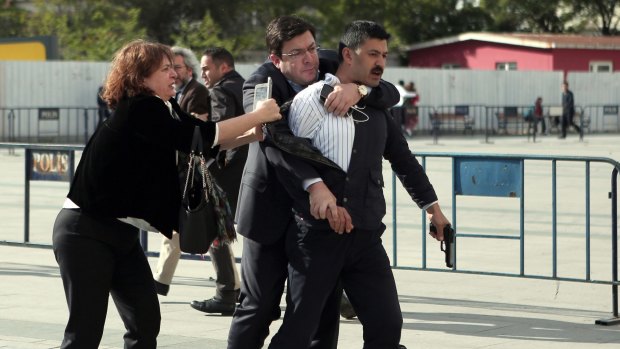Journalist Can Dundar's wife and lawyer overpower the gunman.