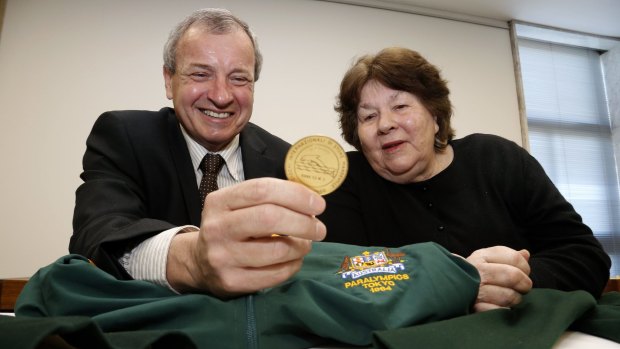Greg Hartung looks at the uniforms and medals donated to the Australian Paralympic Committee by Australia's first female Paralympian Daphne Hilton in 2012. 