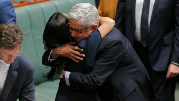 Liberal MP Ken Wyatt hugs Labor MP Linda Burney following her maiden speech.