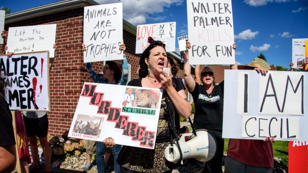 Rachel Augusta leads a group of protesters in front of Walter Palmer's dental practice.