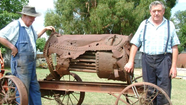 Bungendore brothers Coin and Dave Daniel photographed in 2002 in their Bungendore backyard with the remains of the boiler from the Pioneer a paddlesteamer which plied the waters of Lake George in the late 1800s.