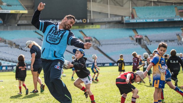 Tip! NSW Blues player Andrew Fifita tries to get away from a dogged defender at ANZ Stadium.