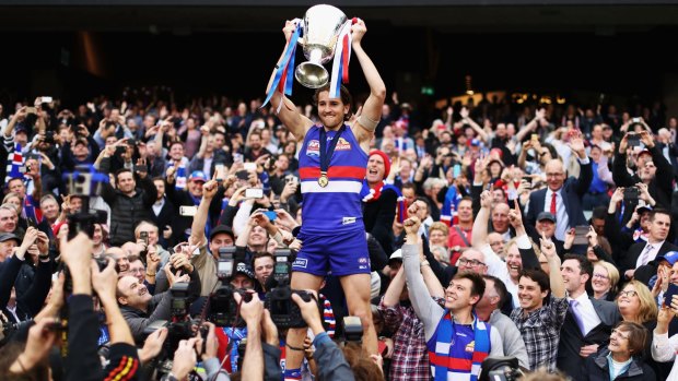 Nick Dal Santo's cousin, Marcus Bontempelli of the Bulldogs, celebrates with the premiership cup.
