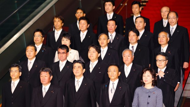 Shinzo Abe, front centre, poses with his new Cabinet at the Prime Minister's official residence in Tokyo on Thursday.