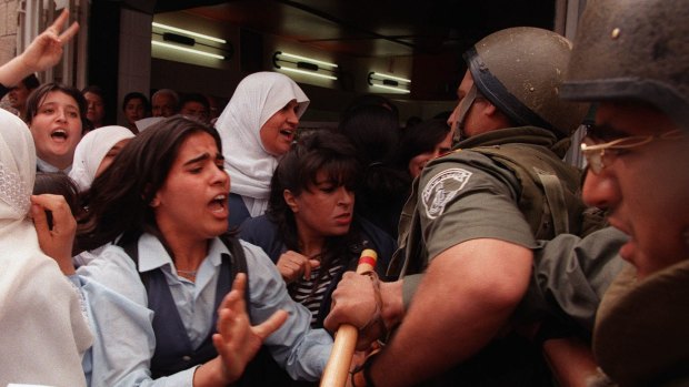Palestinian residents of occupied East Jerusalem struggle with Israeli police in May 1998, after officers tried to break up a march commemorating the 50th anniversary of the Nakba.   