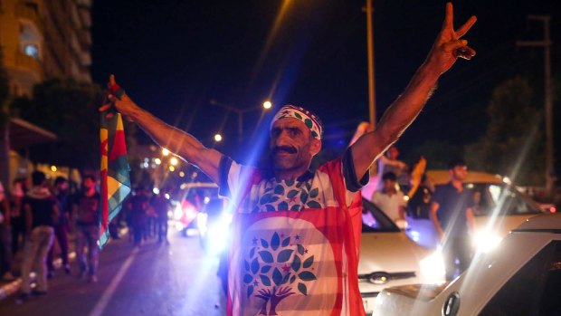 A supporter of the pro-Kurdish Peoples' Democratic Party (HDP) celebrates June election results in Diyarbakir, Turkey.