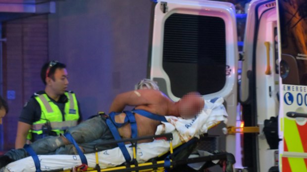 A man subdued by police and arrested after a fight in Collins Street.Photo.