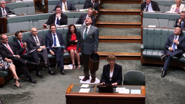 An attendant mops up a leak from the roof during question time. 