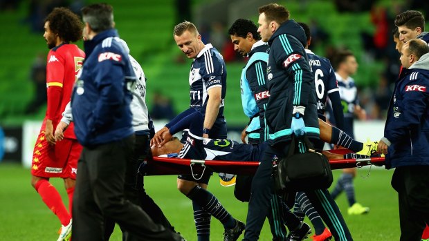 A distraught Archie Thompson is taken off the field with a knee injury.
