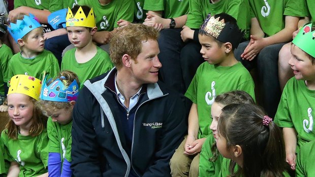 'Where is your crown?' ... Britain's Prince Harry (centre) talks to pupils during a visit to Halfmoon Bay School in Oban on Stewart Island, New Zealand.