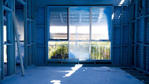 Inside  a Mr Fluffy house in Scullin prior to demolition. The blue paint is from a PVA/paint mixture that minimises the possibility of airborne asbestos.
