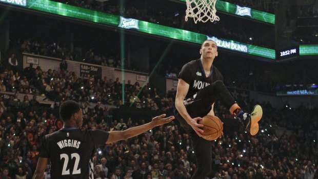 Zach LaVine, right, takes the ball from teammate Andrew Wiggins as he competes during the NBA All-Star Saturday Slam Dunk Contest.