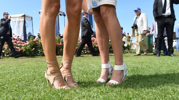 Racegoers in heels at Flemington racecourse during Melbourne Cup day, 2015.