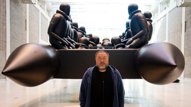 Ai Weiwei in front of his work The Law of the Journey. 