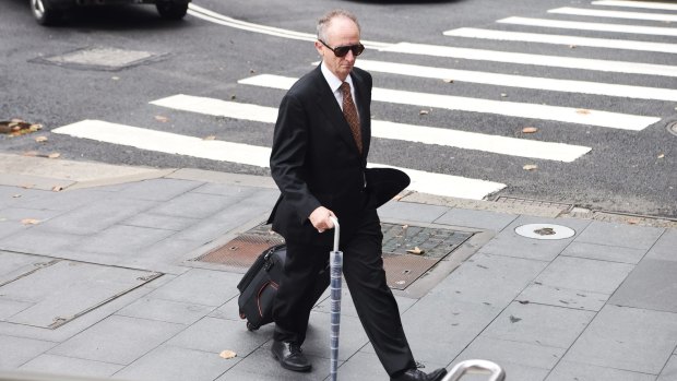 Mark Tedeschi, QC, enters the NSW Supreme Court 