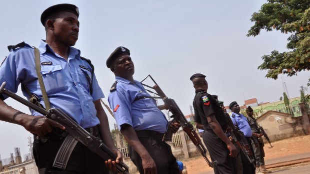 Nigeria police patrol the city of Abuja after the national elections scheduled for February 14 were postponed. 