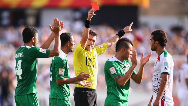 Referee Ben Williams sends Mehrdad Pooladi off in the Asian Cup quarter-final between Iran and Iraq at Canberra Stadium.