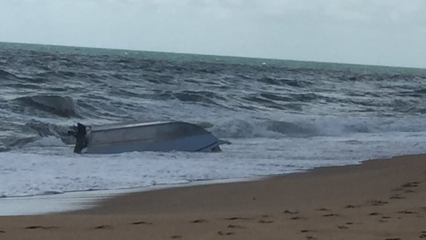 Three men made it back to shore while clinging to the hull of their dinghy which capsized near Baffle Creek, north of Bundaberg.