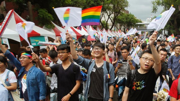 Same-sex marriage supporters cheer after Taiwan's Constitutional Court ruled in favour of it.