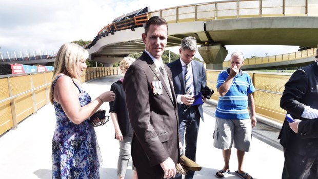 Afghanistan veteran Scott Tate, wearing his relatives' medals earned in World War I and his own, attended the official opening of the  Albert "Tibby" Cotter walkway. 