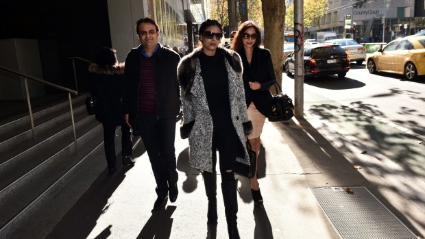 Pankaj Oswal (left) and his wife Radhika (right) and daughter Vasundhara leave court in Melbourne: There is little doubt it was the bank that blinked first.