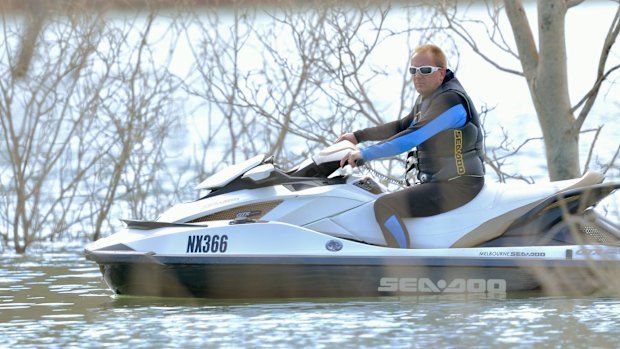 A man searching Lake Eildon on Monday. 