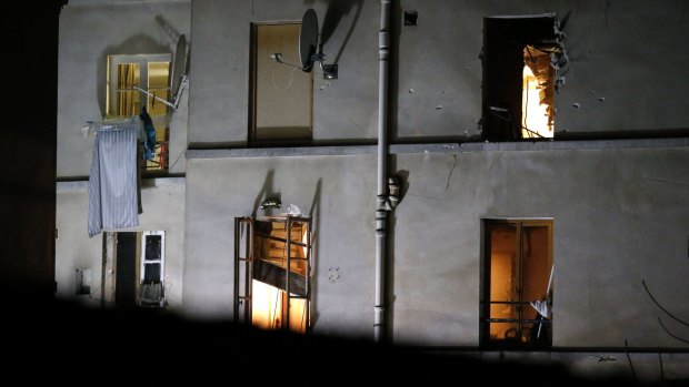 Bullet holes and smashed windows on the back of the building after the raids in Saint-Denis, Paris, on Wednesday.