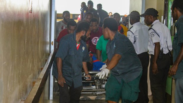 An injured student is rushed to the emergency room at Port Moresby General Hospital on Wednesday. 