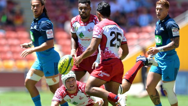 Michael Gunn of the Queensland Reds passes the ball during the Rugby Global Tens match between the Queensland Reds and Auckland Blues at Suncorp Stadium.