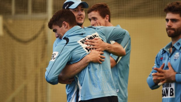Back in the fold: Sean Abbott is embraced by Kurtis Patterson at NSW training this morning.