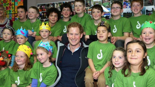 A hit with the kids ... Prince Harry sits with pupils at Halfmoon Bay School in Oban, New Zealand.