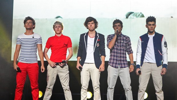 Harry Styles (middle) with One Direction on stage in Australia in 2012. 