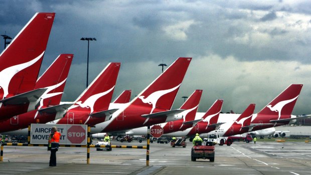 Qantas banned a passenger who asked to be removed from a flight because an asylum seeker was on board.