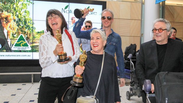 Triumpant ... director George Miller and three of his Oscar-winning team ... Margaret Sixel, left, Lesley Vanderwalt and Damian Martin - arrive back in Sydney.