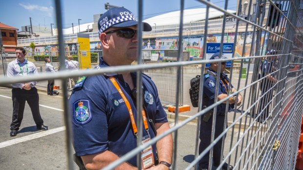 Police watch demonstrators ahead of the G20 summit in Brisbane. 