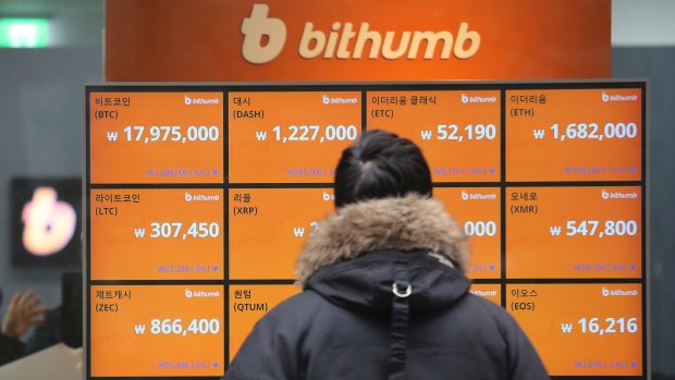 A man watches a screen showing the prices of bitcoin at a virtual currency exchange office in Seoul, South Korea.