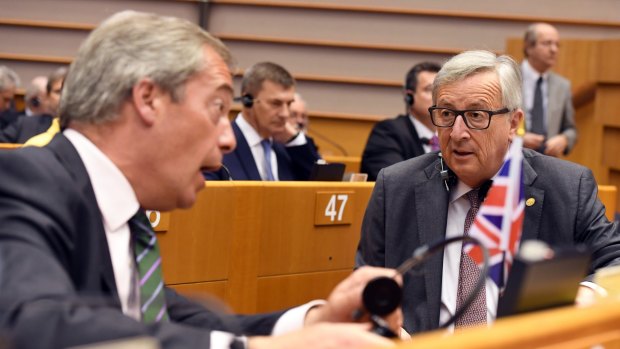 European Commission President Jean-Claude Juncker speaks with  Nigel Farage.