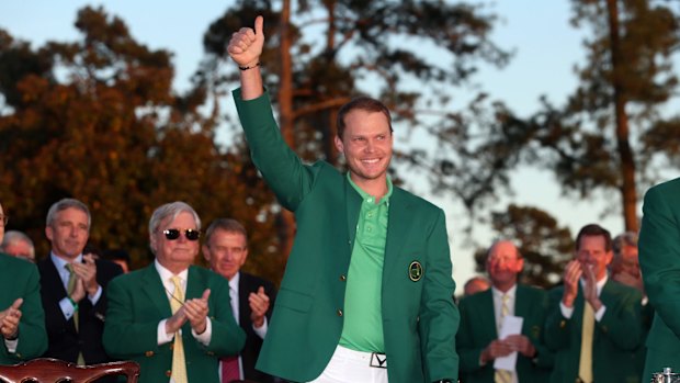 On the rise: Danny Willett celebrates his victory at Augusta.