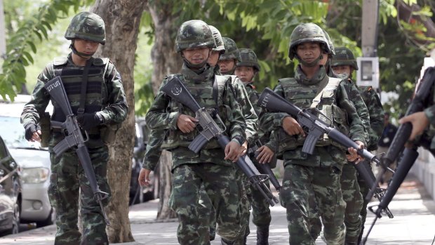 Thai soldiers march on a street in Bangkok. Thailand's junta chief has given the military broad new police-like powers to arrest and detain criminal suspects, in an unannounced move that rights groups criticised as a recipe for human rights violations. 