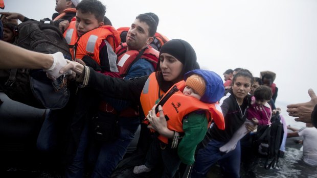 Refugees arrive on Lesbos on Wednesday after crossing the Aegean Sea from Turkey on an inflatable dinghy.